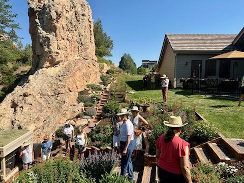 a group exploring a beautiful local garden in a backyard.