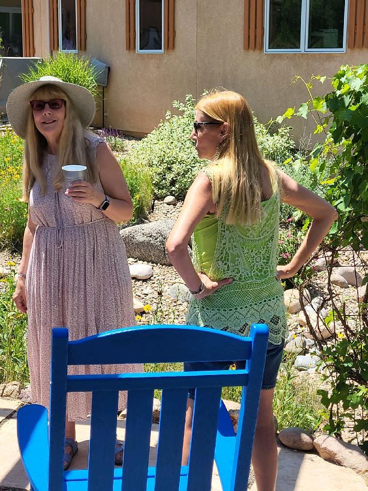 2 women standing in a garden on a hot sunny day